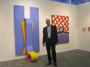 Dealer Gary Snyder flanked by works by Sven Lukin, 1965, and Nicholas Krushenick, 1962.