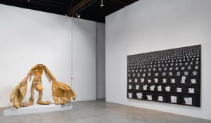Installation shot, Tim Hawkinson, Scout, 2006-2007, Cardboard, box strapping and urethane foam, 72 x 100 x 58 inches; and, Veil, 2006, Photo collage and urethane foam on panel, 81 x 144 Inches