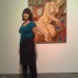 Candace Mills posing with a work by Philip Pearlstein