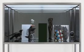 Josephine Meckseper, Afrikan Spir, 2011. Mixed media in steel and glass vitrine, 80 x 80 x 20 Inches, Courtesy the FLAG Art Foundation