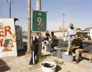 David Goldblatt, At Kevin Kwanele’s Takwaito Barber, Lansdowne Road. Khayelitsha, Cape Town in the time of AIDS.16 May 2007. Digital print in pigment inks on 100% cotton rag paper, 90 x 111 cm. Courtesy of Goodman Gallery, Johannesburg