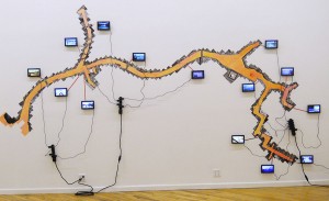 Henry Sanchez, NTWKDKMCEK, 2011. LCD Monitors, adhesive synthetic paper, mixed media, 120 x 240 x 20 inches (variable). Courtesy of the Artist