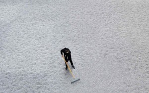 A worker at Tate Modern combing Ai Weiwei's Sunflower Seeds installation in the Turbine Hall, 2010. Photo: Paul Grover / Daily Telegraph