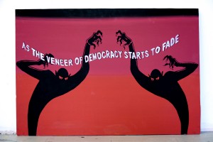 Rupert Goldsworthy, As the Veneer of Democracy Starts to Fade, 2011.acrylic and Flasche on wood, 24 x 36 inches. Courtesy of Rupert Goldsworthy*