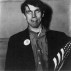 Diane Arbus,?Patriotic young man with a flag,?1967. Gelatin silver print,?14 x 14 inches. Reproduced in the book under review.