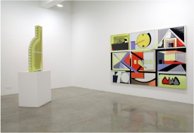 installation shot of the exhibition under review with Thomas Scheibitz, Standard, 2011, MDF, wood, vinly, lacquer and spray paint, 55-1/2 x 26-3/4 x 5-1/8 inches, to right, and A Panoramic VIEW of Basic Events, 2011 [details in preceding slide] to right. Courtesy of Tanya Bonakdar Gallery