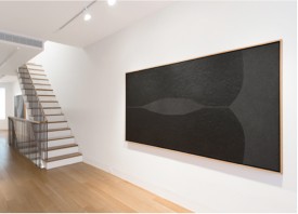 Installation shot of the exhibition under review with Alberti Burri, Nero Cellotex, 1986-1987. Acrylic and Vinavil on Celotex, 50 x 98 inches. Courtesy Fondazione Palazzo Albizzini Collezione Burri © 2013 Artists Rights Society (ARS), New York / SIAE, Rome.