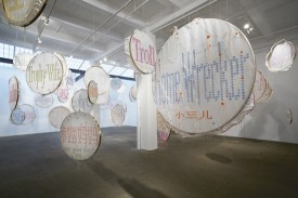 Lin Tianmiao, Badges, 2011-12, White silk, colored silk thread, painted stainless steel embroidery frame, sound component Installation dimensions variable. Installaed in the artist’s 2012 exhibition at Galerie Lelong, New York. Courtesy Galerie Lelong