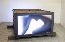 Marck, Frauenkiste", 2007. LCD, iron, glass , 37 x 24 x 47 inches with 09:57 movie loop. Courtesy of Galerie von Braunbehrens