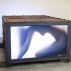 Marck, Frauenkiste", 2007. LCD, iron, glass , 37 x 24 x 47 inches with 09:57 movie loop. Courtesy of Galerie von Braunbehrens