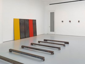 Works by Richard Nonas including Hunk, 2008, foreground, and teel Drawing, 5 Plates: One Red, One Yellow, XX 1988. Courtesy of Fergus McCaffrey