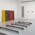Works by Richard Nonas including Hunk, 2008, foreground, and teel Drawing, 5 Plates: One Red, One Yellow, XX 1988. Courtesy of Fergus McCaffrey