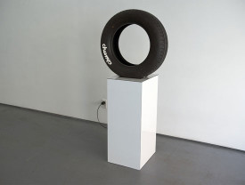 Carlo Ferraris, Going North East, 2015, Tire, text, motor, pedestal, 56 ½ x 24 x 16 ½ inches, Courtesy LYNCH THAM