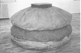 Claes Oldenburg, Floor Burger, 1962 (on view at Green Gallery in 1962). Acrylic on canvas filled with foam rubber and cardboard boxes, 52 x 84 inches. Art Gallery of Ontario. Original title: Giant Hamburger.
