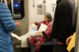 A Book as a Bridge by Elena Berriola, performance, 2 Train from Wall Street to the Bronx, Monday, November 23, 2015. Photo: Sara Pettinella