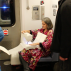 A Book as a Bridge by Elena Berriola, performance, 2 Train from Wall Street to the Bronx, Monday, November 23, 2015. Photo: Sara Pettinella