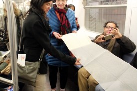 A Book as a Bridge by Elena Berriola, performance, 2 Train from Wall Street to the Bronx, Monday, November 23, 2015. Photo: Sara Pettinella