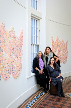 Resource: Art curators Emily Tucker, Elisabeth Samuels and (seated) Anna Kaplan at the Hotel Henry with works by Ani Hoover. Courtesy of the Buffalo Spree