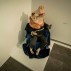 Installation shot of the exhibition under review, showing a papier maché pig in satin clothes.