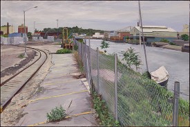 Scott Williams, Fenced Waterfront, 2017. Oil on panel, 18 x 28 inches. Courtesy of the artist
