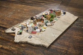 Charles LeDray, Free Public Library, 2015-2019. Paper, cardboard, fabric, thread, acrylic paint, ink, acrylic varnish, acrylic gel medium, brass, patina, bubble gum, glass, metal, wire, wood, cement board, cement, granite, glue, fiberfill, Mylar, 10-1/8 x 97-1/8 x 50-1/4 inches. Courtesy of the artist and Peter Freeman, Inc.