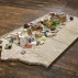 Charles LeDray, Free Public Library, 2015-2019. Paper, cardboard, fabric, thread, acrylic paint, ink, acrylic varnish, acrylic gel medium, brass, patina, bubble gum, glass, metal, wire, wood, cement board, cement, granite, glue, fiberfill, Mylar, 10-1/8 x 97-1/8 x 50-1/4 inches. Courtesy of the artist and Peter Freeman, Inc.