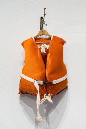 Charles LeDray, Life Vest / Hotel Manhattan, 2018. Fabric, thread, twill tape, Kapok, paint, varnish, brass, steel, patina, firescale, wood, wax, embroidery floss, 13-7/8 x 8-1/4 x 6-1/4 inches. Courtesy of the artist and Peter Freeman, Inc.