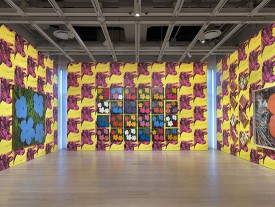 Installation shot of the exhibition under review, showing Andy Warhol Flower Paintings and Cow Wallpaper. © The Andy Warhol Foundation for the Visual Arts, Inc. / Licensed by Artists Rights Society (ARS),