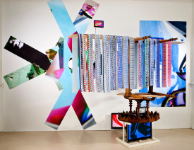 Dragons of Iceland Installation, 2011. Tables, plywood, flat screen TVs, video players, DVD player, inkjet printed video stills on paper, 120 x 140 x 60 inches. Photo by Greg Leshé, courtesy of SL Gallery.